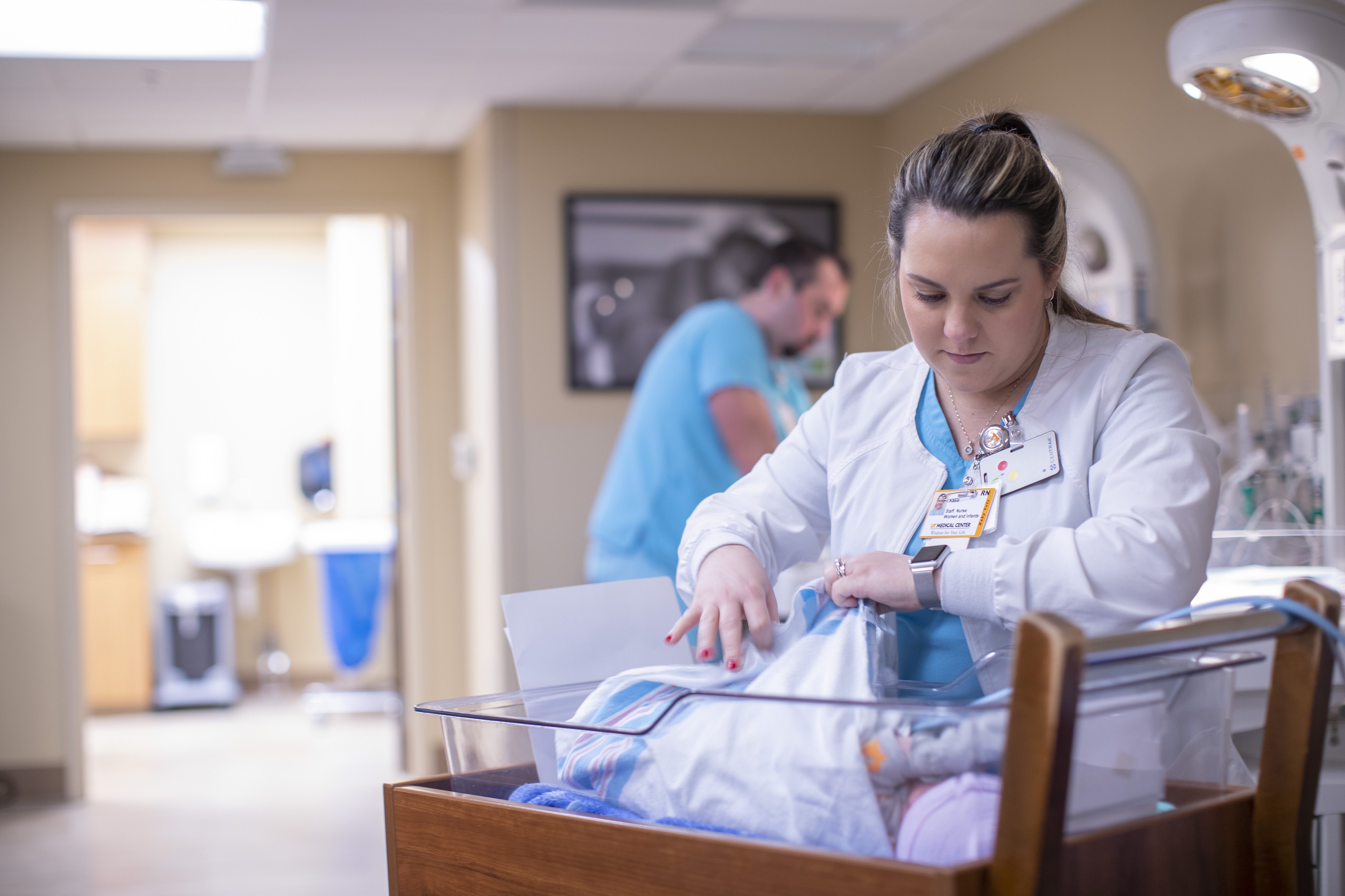 A NICU nurse watches over a premature baby
