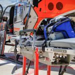 UT LIFESTAR aeromedical helicopter and stretcher on hospital landing pad