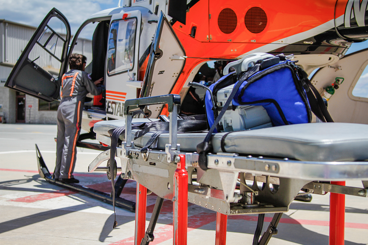 UT LIFESTAR aeromedical helicopter and stretcher on hospital landing pad