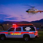 UT LIFESTAR aeromedical helicopter hovers over a fire department rescue vehicle