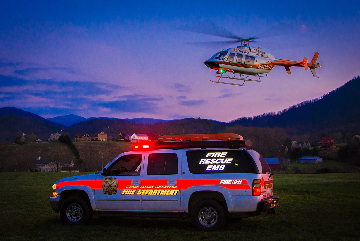 UT LIFESTAR aeromedical helicopter hovers over a fire department rescue vehicle