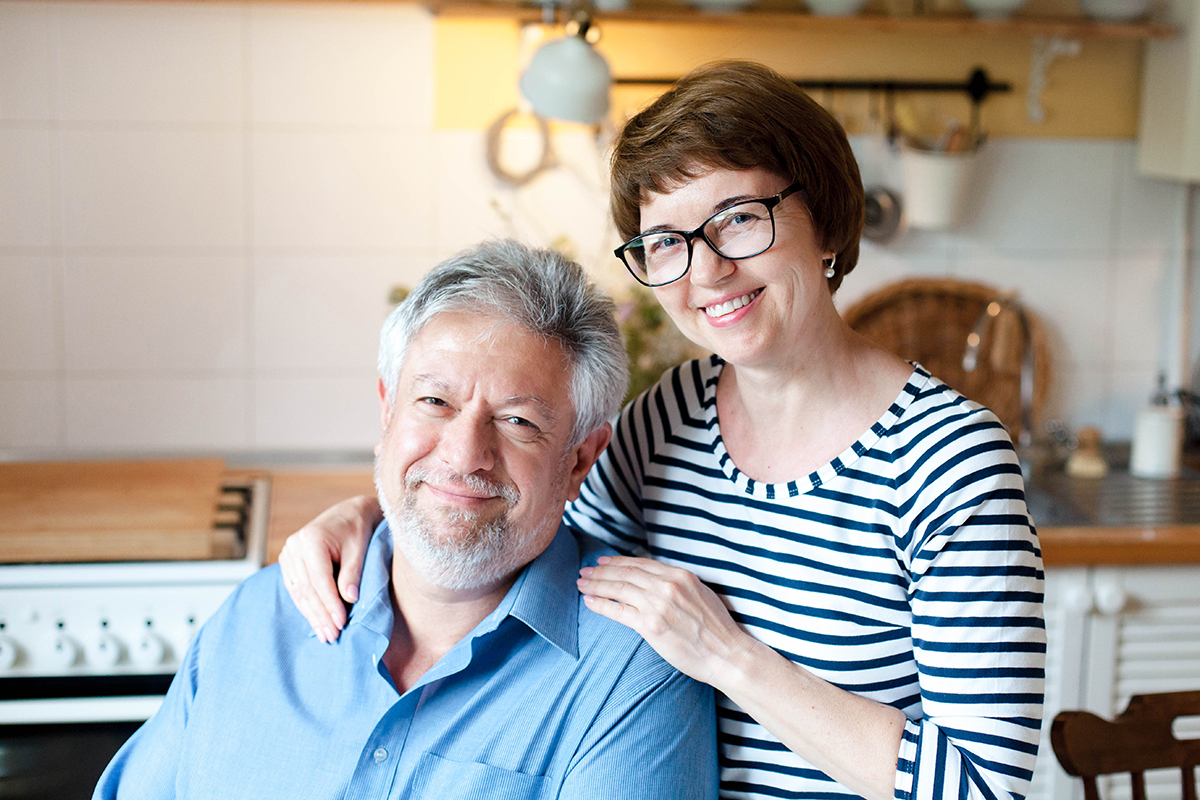 Middle-aged couple standing in their kitchen