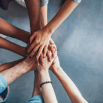 People in bariatric support groups stacking hands to show they support each other