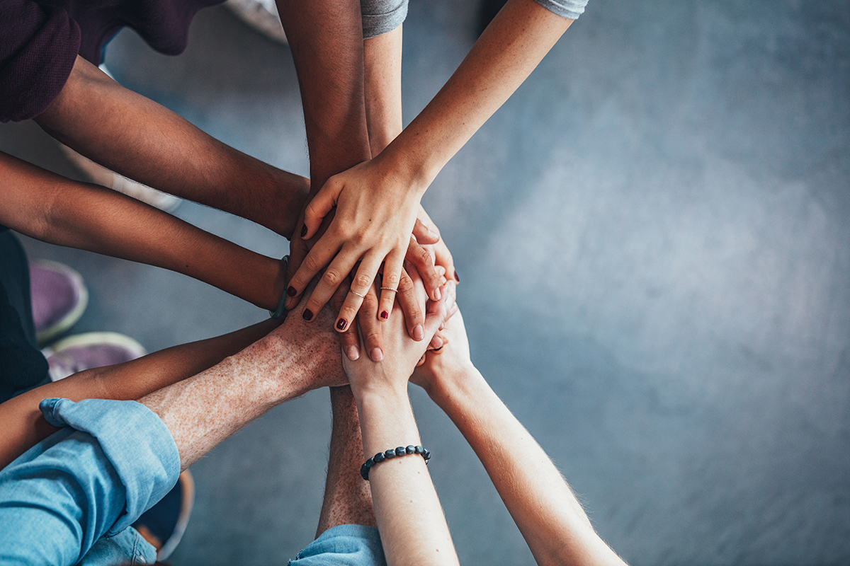 People in bariatric support groups stacking hands to show they support each other